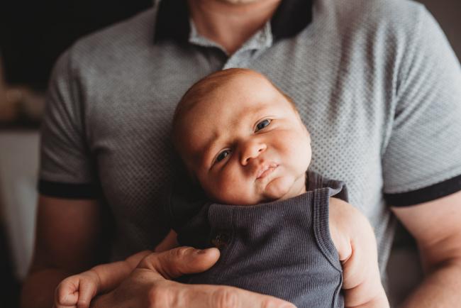 Newborn baby with funny expression with lifestyle newborn photographer Perth