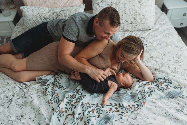 Lifestyle-Newborn-Photographer-Perth-36-of-69 Parents laying with newborn baby on bed with in-home lifestyle newborn photographer Perth