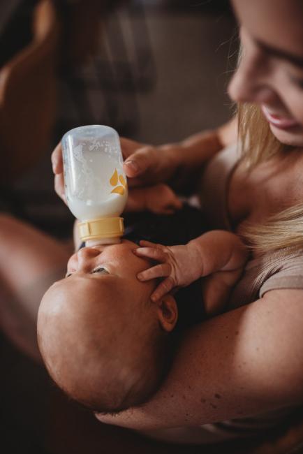 Lifestyle-Newborn-Photographer-Perth-45-of-69 Top down image of baby being bottle fed with Perth newborn photographer