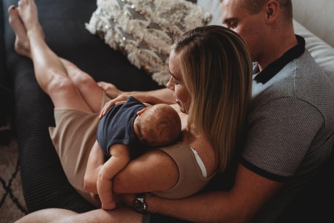 Lifestyle-Newborn-Photographer-Perth-5-of-69 Top down image of mother and father on couch with newborn baby with in-home lifestyle newborn photographer Perth