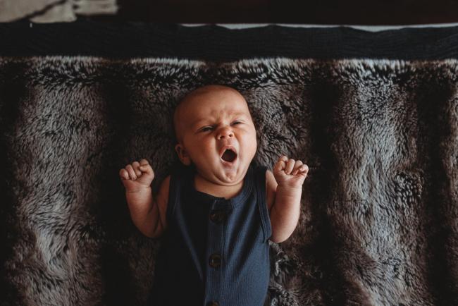 Newborn baby yawning with Perth lifestyle newborn photographer