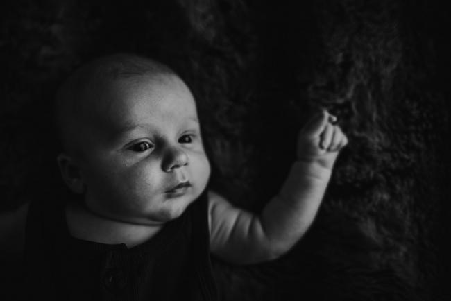 black and white image of newborn baby with lifestyle newborn photographer Perth