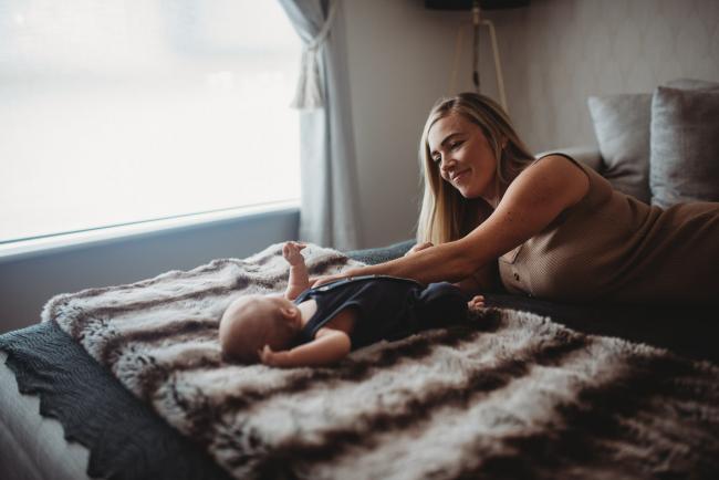 Lifestyle-Newborn-Photographer-Perth-59-of-69 Newborn baby on blanket as mother reaches over to touch him with Perth lifestyle newborn photographer