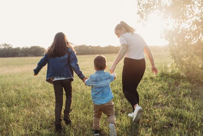 Three siblings holding hands during Perth family photographer session at Perry's Paddock