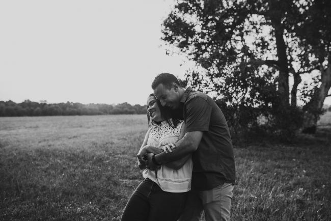 black and white image of couple hugging and laughing during Perth couples photographer session at Perry's Paddock