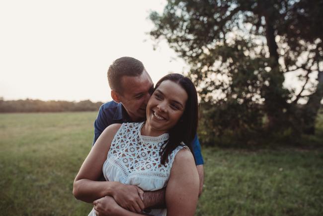 Man kissing his partners neck during Perth couples photographer session at Perry's Paddock