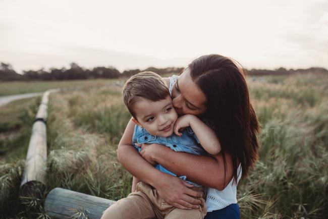 Mother kissing son during Perth family photographer session at Perry's Paddock