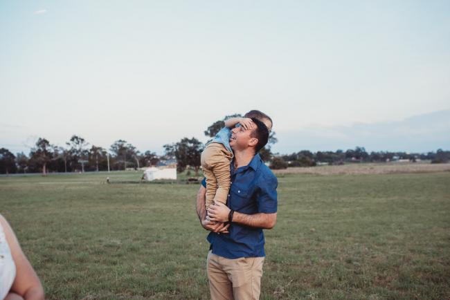 Father with son over his shoulder during Perth family photographer session at Perry's Paddock