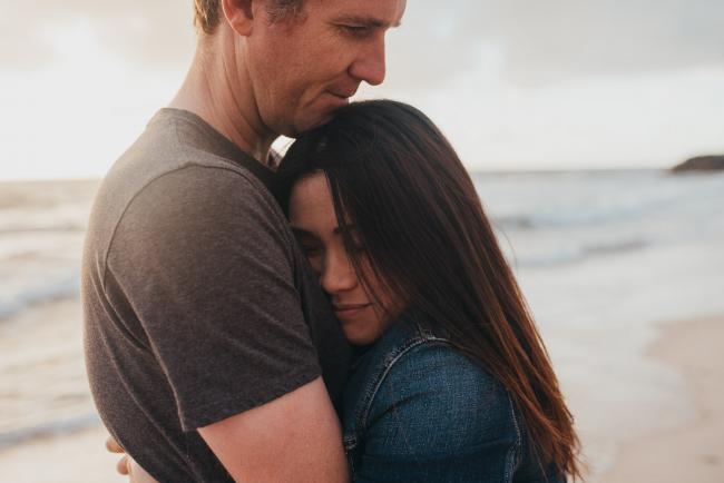 Couple hugging at Burns Beach with Perth Family Photographer