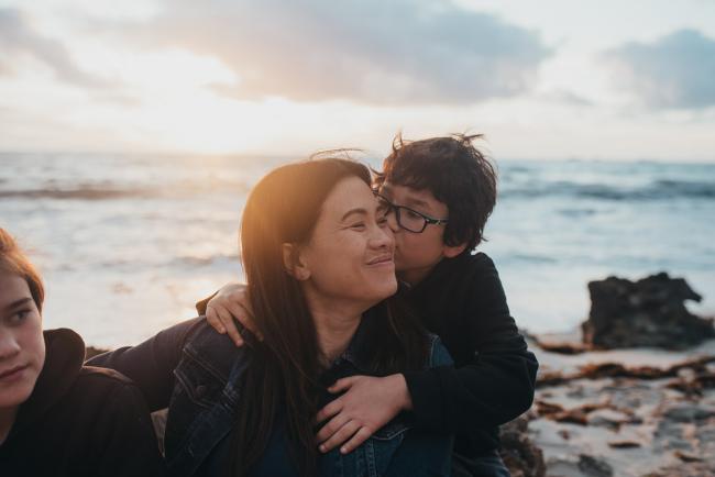 Family-Photographer-Perth-Burns-Beach-34-of-57 Son kissing mother at Burns Beach with Perth Family Photographer