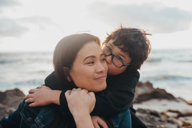 Boy kissing mother at Burns Beach with Perth Family Photographer