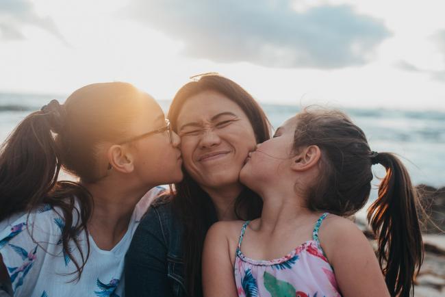 Family-Photographer-Perth-Burns-Beach-39-of-57 Daughters kissing mothers cheek at Burns Beach with Perth Family Photographer