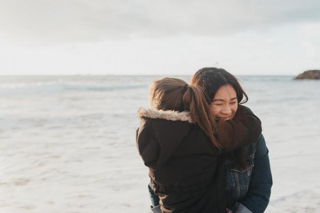 Daughter hugging mother at Burns Beach with Perth Family Photographer