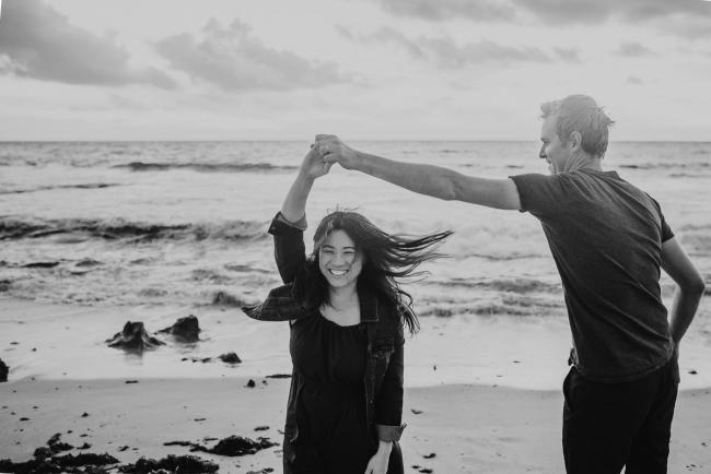 Family-Photographer-Perth-Burns-Beach-55-of-57 Black and white image of couple dancing on beach at Burns Beach with Perth Family Photographer