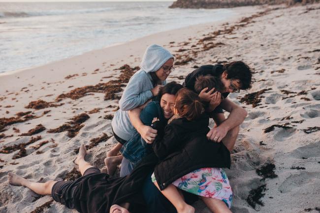 Family-Photographer-Perth-Burns-Beach-56-of-57 Kids piling on top of parents at Burns Beach with Perth Family Photographer