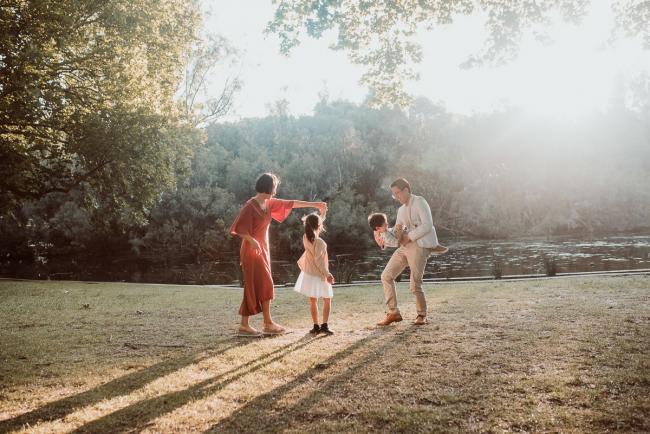 Family-Photographer-Perth-Hyde-Park-12-of-54 Mother dancing with daughter and father holding son upside down during Perth extended family session at Hyde Park with Perth family photographer