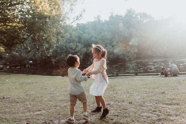 Family-Photographer-Perth-Hyde-Park-15-of-54 Brother and sister holding hands and spinning during Perth extended family session at Hyde Park with Perth family photographer