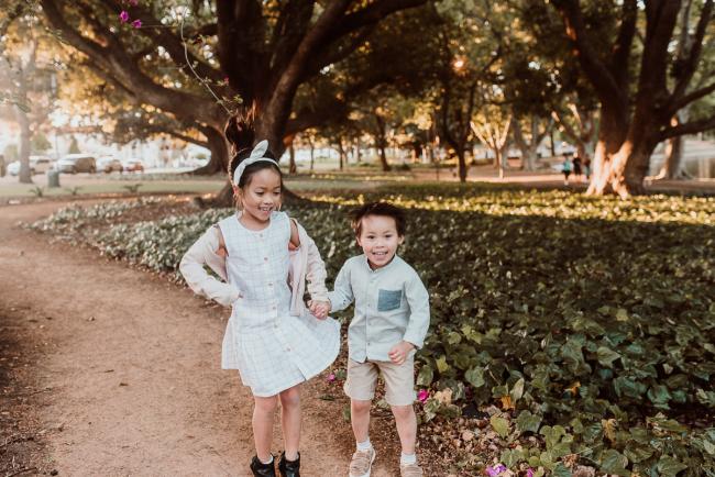 Family-Photographer-Perth-Hyde-Park-31-of-54 Brother and sister holding hands and jumping during Perth extended family session at Hyde Park with Perth family photographer