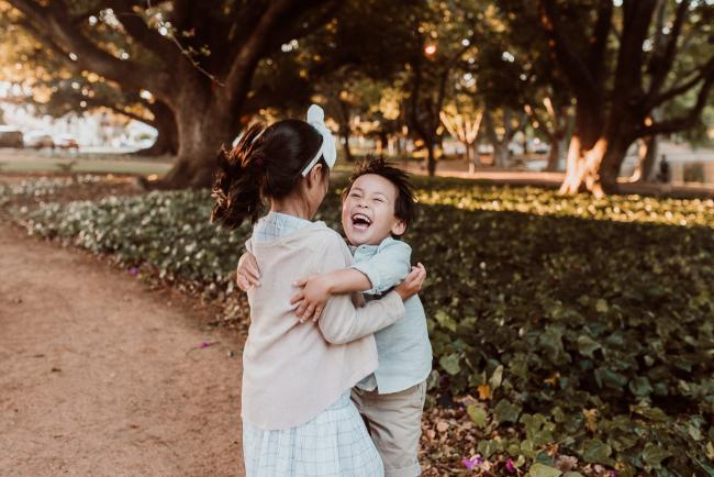 Family-Photographer-Perth-Hyde-Park-32-of-54 Brother hugging sister and laughing during Perth extended family session at Hyde Park with Perth family photographer
