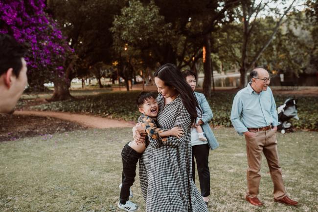 Family-Photographer-Perth-Hyde-Park-47-of-54 Mother lifting son during Perth extended family session at Hyde Park with Perth family photographer