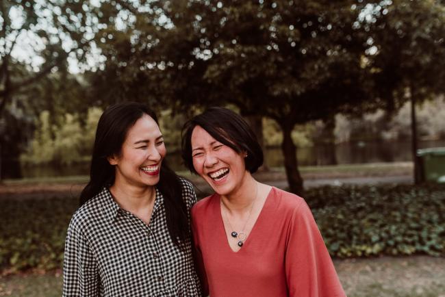 Family-Photographer-Perth-Hyde-Park-52-of-54 Grown up sisters laughing during Perth extended family session at Hyde Park with Perth family photographer