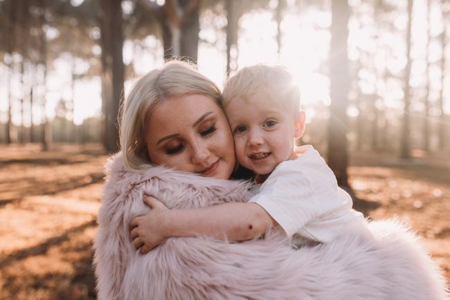 Family-Photographer-Perth-The-Pines-18-of-29 Mother and son hugging with blanket wrapped around them during Perth family photography session at The Pines Wanneroo