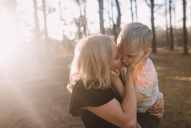 mother kissing son at the Pines Wanneroo with Perth family photographer