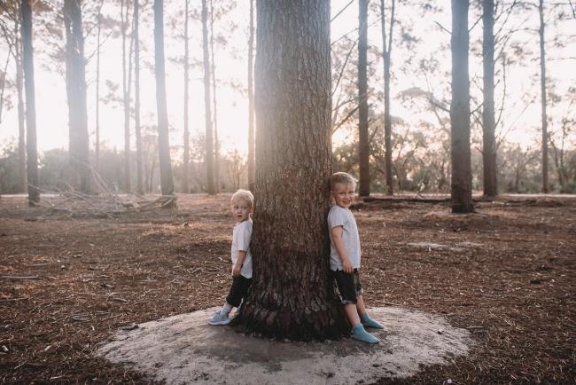 Family-Photographer-Perth-The-Pines-25-of-29 Boys leaning against tree during Perth family photography session at The Pines Wanneroo