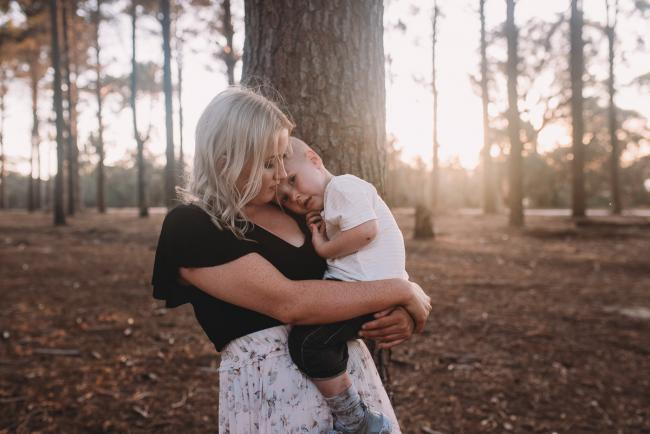 Family-Photographer-Perth-The-Pines-26-of-29 Boy cuddling into mother during Perth family photography session at The Pines Wanneroo