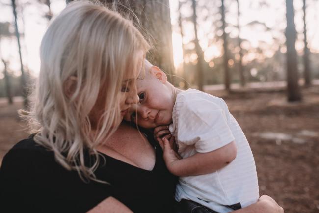 Family-Photographer-Perth-The-Pines-27-of-29 boy resting head on mother during Perth family photography session at The Pines Wanneroo