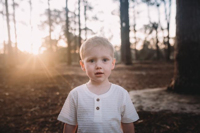 Family-Photographer-Perth-The-Pines-28-of-29 boy looking at camera during Perth family photography session at The Pines Wanneroo
