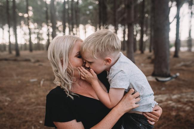 Family-Photographer-Perth-The-Pines-4-of-29 Son kissing mother during Perth family photography session at The Pines Wanneroo