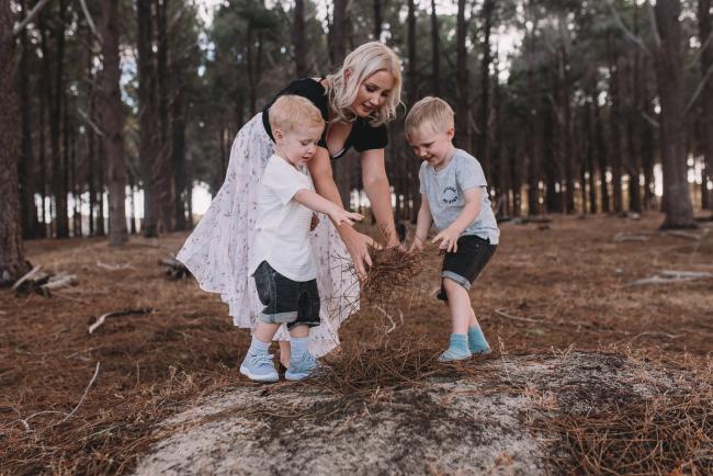 Family-Photographer-Perth-The-Pines-8-of-29 Mother and sons throwing sticks on the ground during Perth family photography session at The Pines Wanneroo