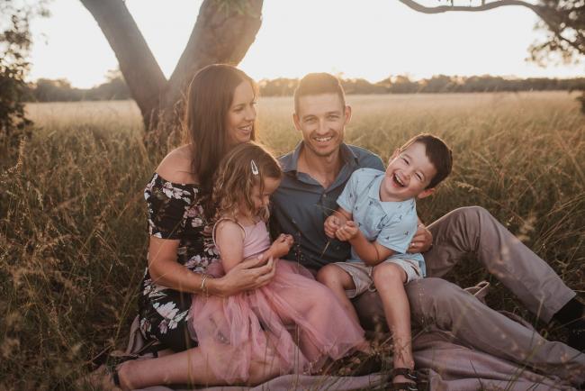 Family of 4 during Perth maternity photography session during golden hour at Perry's Paddock