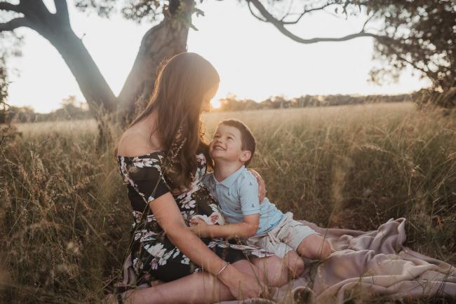 Mother and son looking at each other during Perth maternity photography session during golden hour at Perry's Paddock