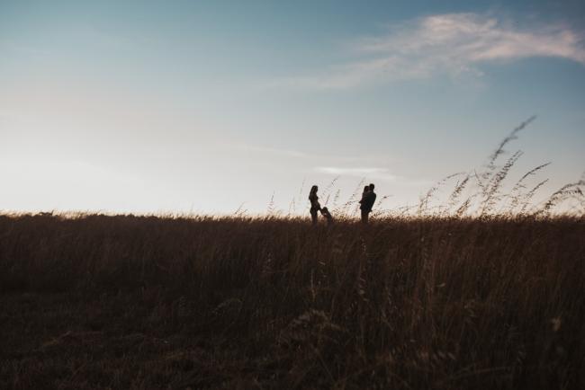 Silhouette of pregnant mother with her two kids and husband during Perth maternity photography session during golden hour at Perry's Paddock