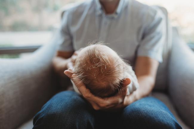 Newborn-Lifestyle-Photographer-Perth-11-of-50 Newborn baby's head in fathers hands during Perth lifestyle newborn photography session