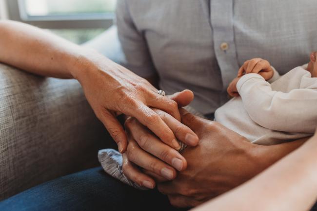 Newborn-Lifestyle-Photographer-Perth-14-of-50 Mother and father holding hands during Perth lifestyle newborn photography session