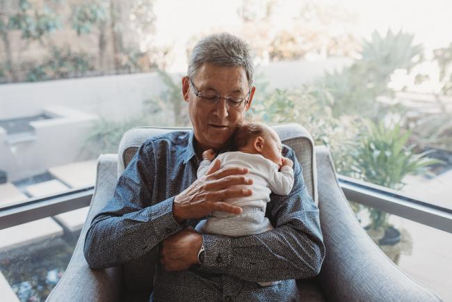 Newborn-Lifestyle-Photographer-Perth-15-of-50 Grandfather holding newborn baby on his chest during Perth lifestyle newborn photography session
