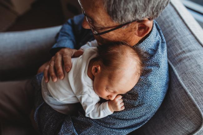 Newborn-Lifestyle-Photographer-Perth-16-of-50 Top down image of newborn baby resting on grandfather's shoulder during Perth lifestyle newborn photography session