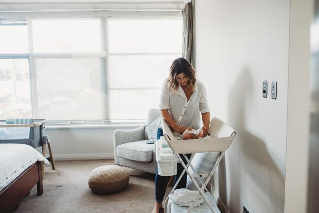 Newborn-Lifestyle-Photographer-Perth-30-of-50 mother changing newborn baby during Perth lifestyle newborn photography session