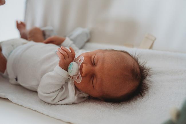 Newborn-Lifestyle-Photographer-Perth-31-of-50 Newborn baby with dummy on change table during Perth lifestyle newborn photography session