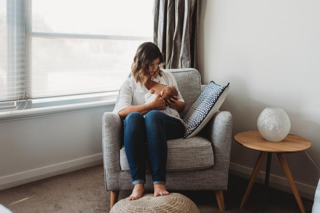 Newborn-Lifestyle-Photographer-Perth-34-of-50 mother breastfeeding newborn baby on couch during Perth lifestyle newborn photography session