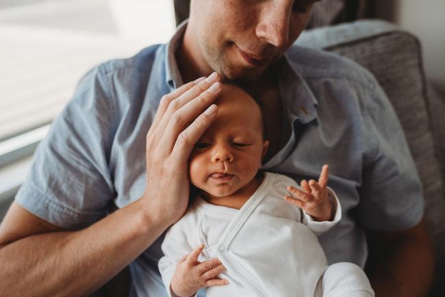 Newborn-Lifestyle-Photographer-Perth-41-of-50 Father holding head of newborn baby during Perth lifestyle newborn photography session