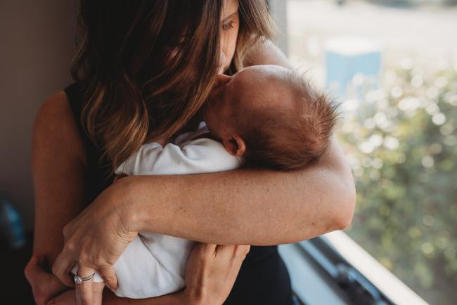 Newborn-Lifestyle-Photographer-Perth-44-of-50 mother kissing newborn baby during Perth lifestyle newborn photography session