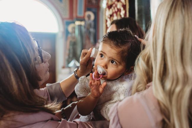 Perth-Events-Photographer-Christening-13-of-25 grandmother brushing granddaughter's hair at baptism at Macedonian Orthodox Church with Perth events photographer