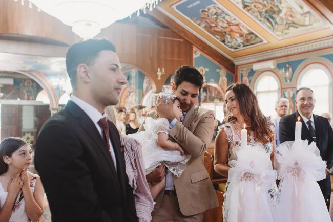 Godfather cuddling little girl at baptism at Macedonian Orthodox Church with Perth events photographer