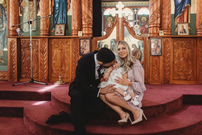 Perth-Events-Photographer-Christening-20-of-25 Parents sitting on steps in church at baptism at Macedonian Orthodox Church with Perth events photographer