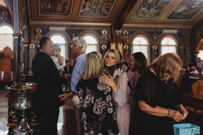 Perth-Events-Photographer-Christening-22-of-25 People hugging at baptism at Macedonian Orthodox Church with Perth events photographer