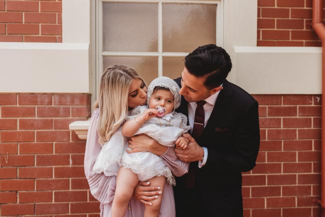 Perth-Events-Photographer-Christening-25-of-25 Parents kissing daughter at baptism at Macedonian Orthodox Church with Perth events photographer